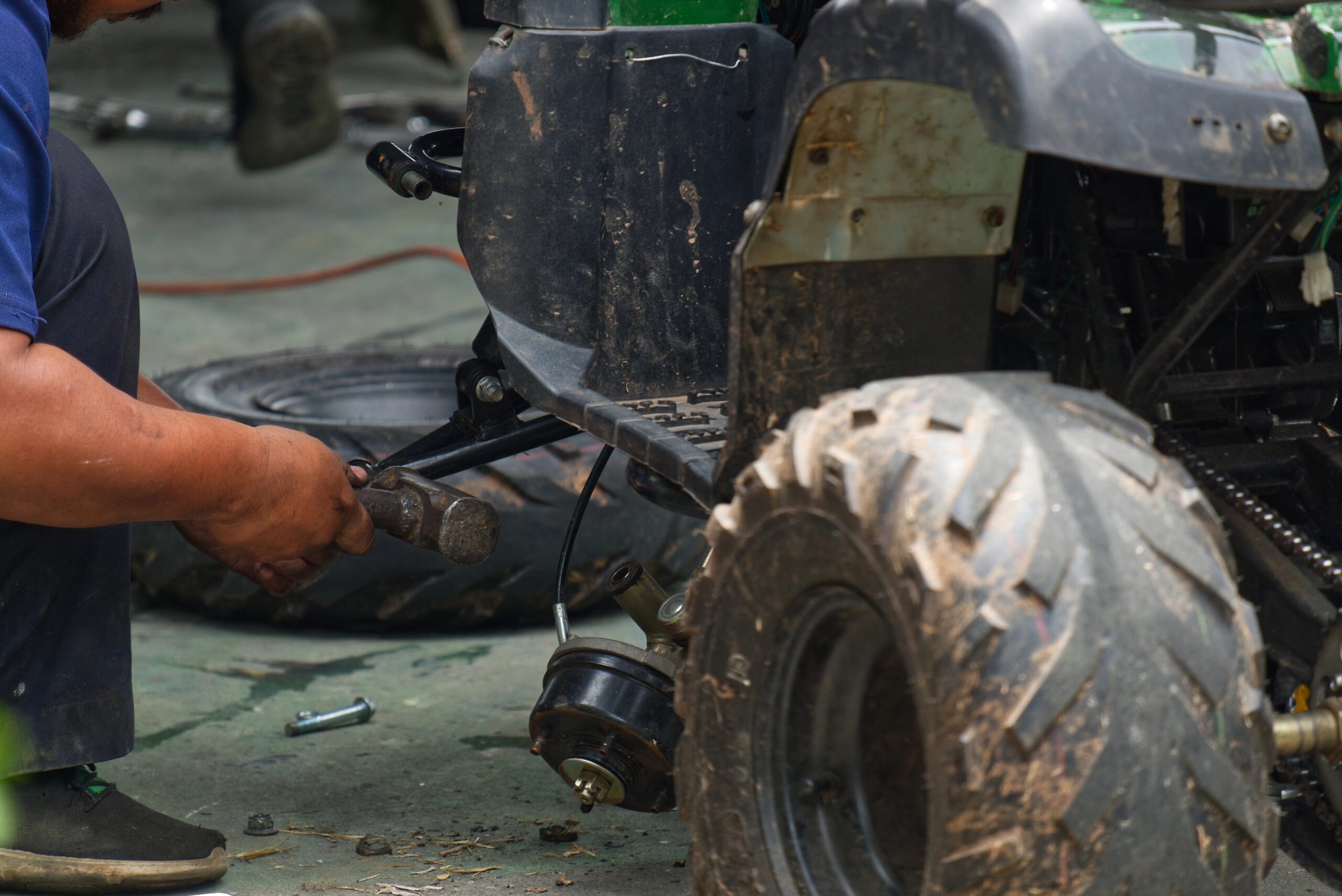 Defective ATV parts injury claims -A damaged ATV being worked on