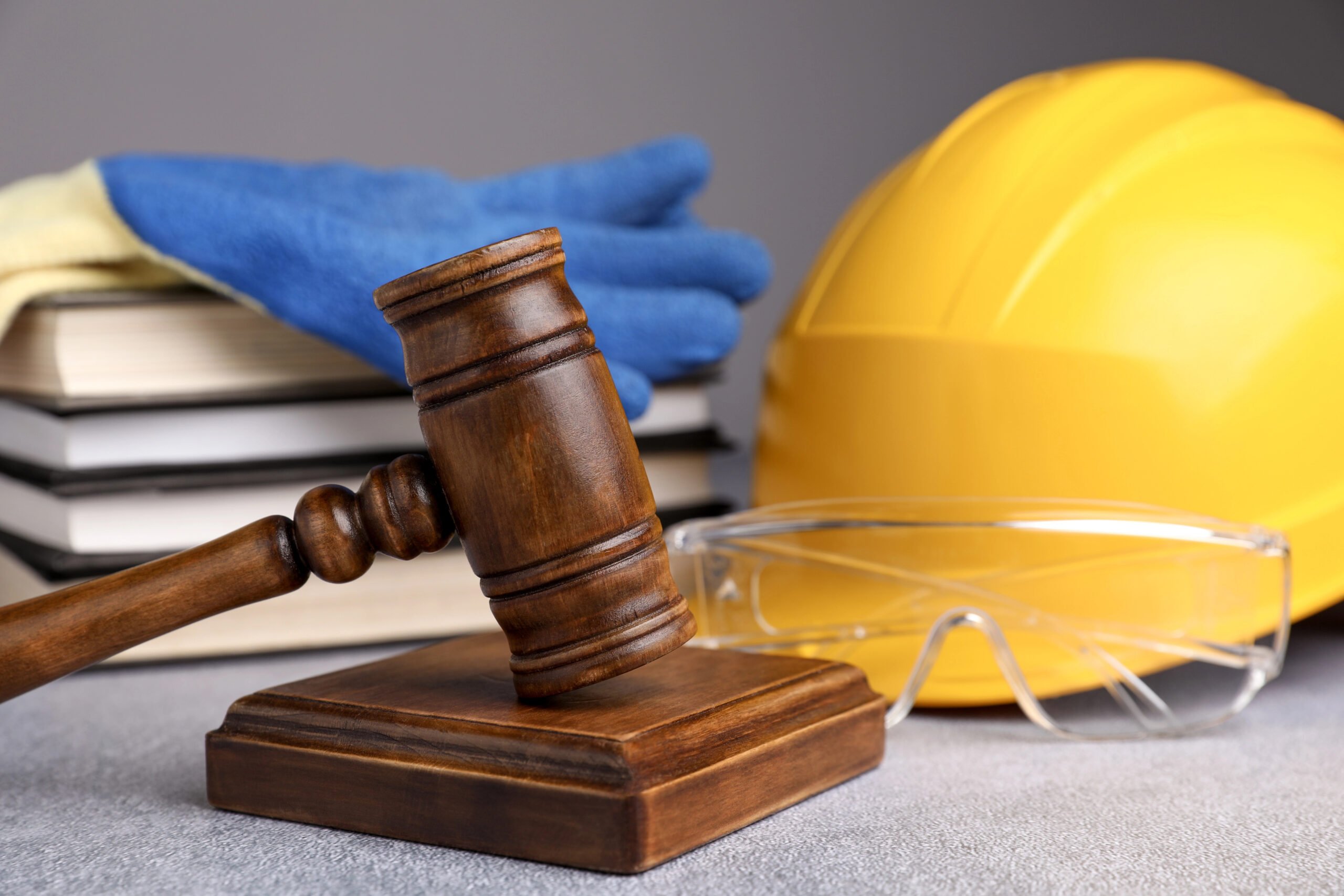 Third-party liability for site injuries - gavel, books and hard hat