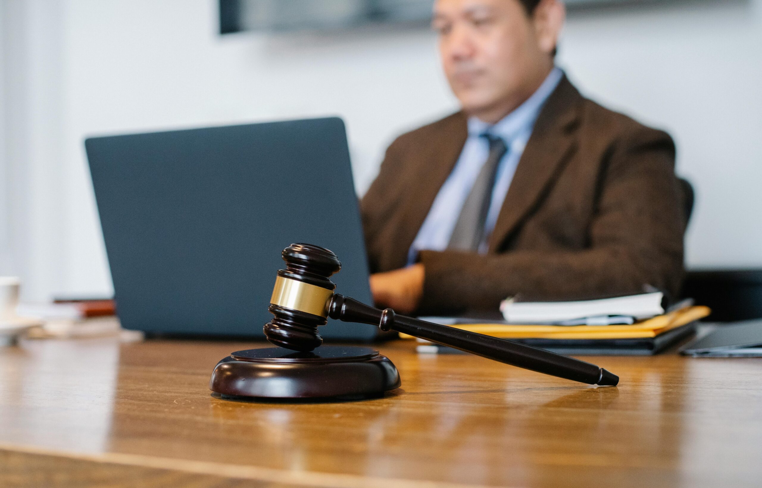 Overloaded cargo shift injury claims - Attorney in his office, with gavel and a laptop
