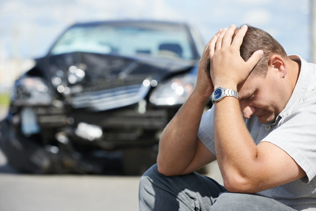 Man with his head in his hands after a Houston car accident, illustrating the need for a Houston car accident attorney.
